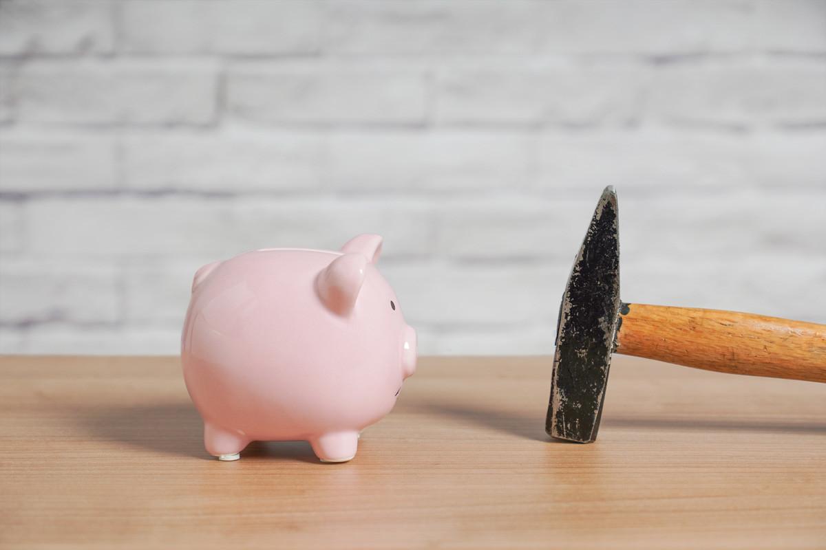 Piggybank and Hammer on Table