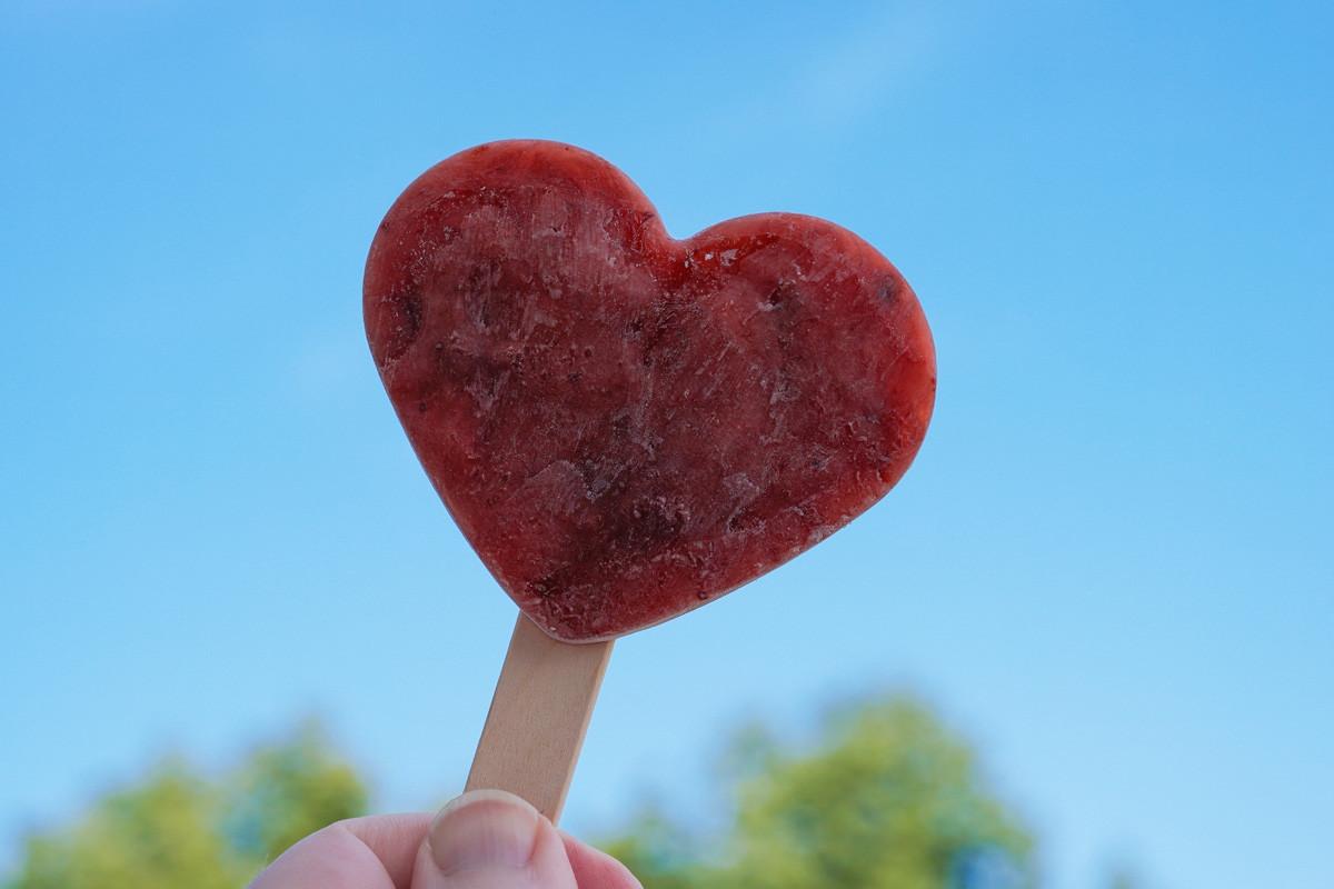 Hand Holding Heart Shaped Popsicle or Ice Lolly