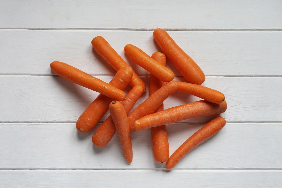 Raw Carrots on White Wooden Table